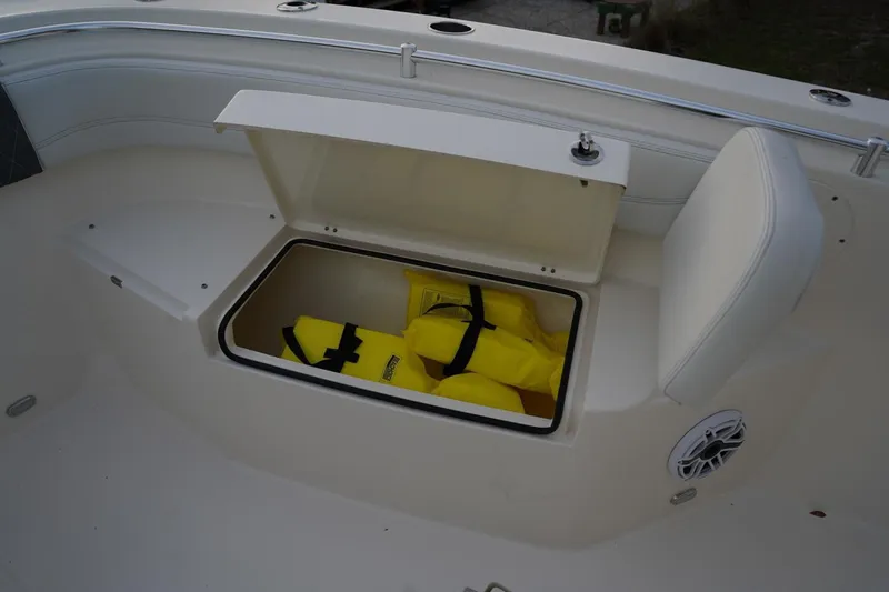 Slide: The Image of 2022 Cobia 266 boat storage compartment with yellow life jackets. - 18
