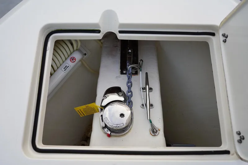 Slide: The Image of Anchor locker of 2022 Cobia 266 boat with chain and winch. - 20