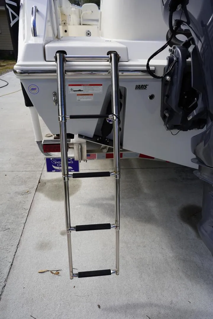Slide: The Image of Stainless steel ladder on 2022 Cobia 266 boat, docked on concrete surface. - 29