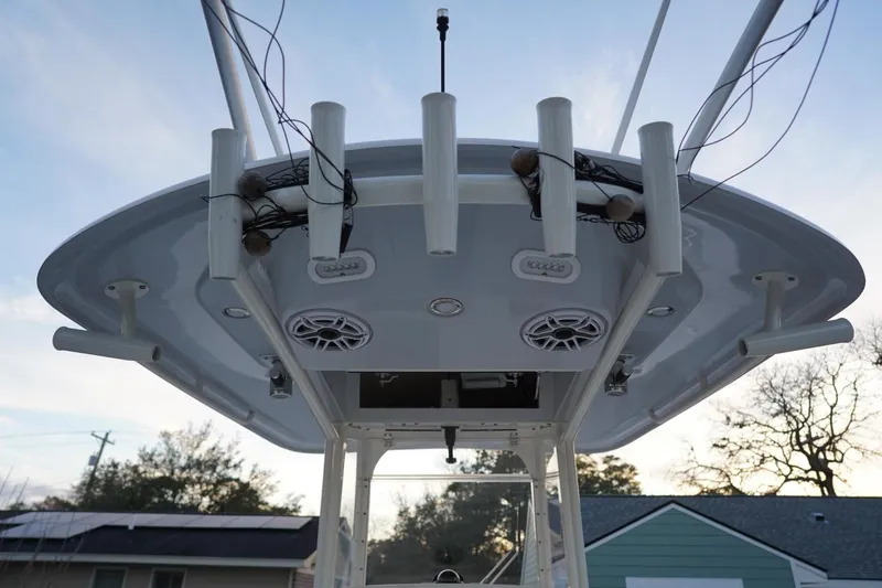 Slide: The Image of 2022 Cobia 266 boat with rod holders and speakers on the T-top. - 3