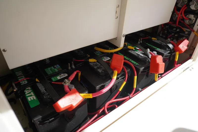 Slide: The Image of Battery compartment of 2022 Cobia 266 boat with multiple batteries and wiring. - 31