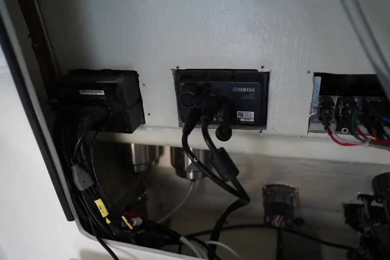 Slide: The Image of Electrical components inside a 2022 Cobia 266 boat, featuring Yamaha connections and wiring. - 34