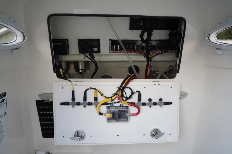 Slide: The Image of Electrical panel of 2022 Cobia 266 boat with wiring and components visible. - 35