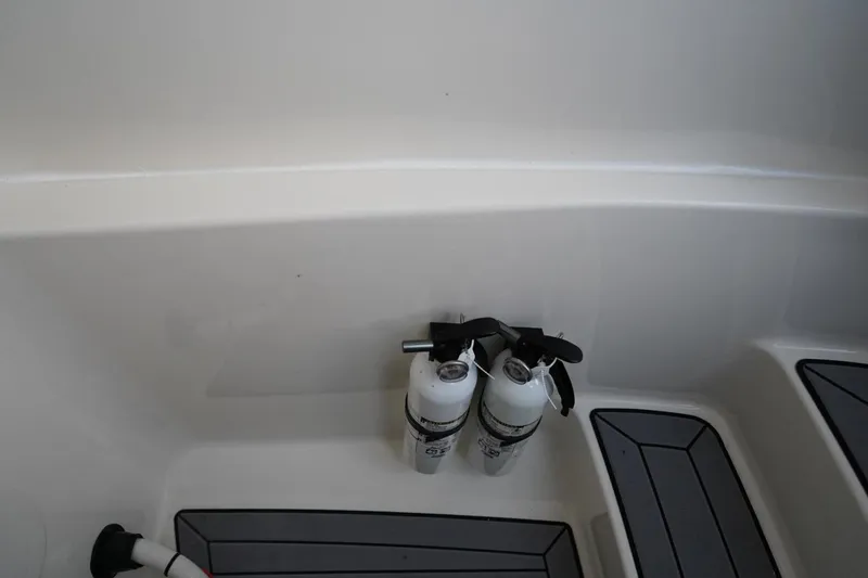 Slide: The Image of 2022 Cobia 266 boat interior with mounted fire extinguishers and non-slip flooring. - 37