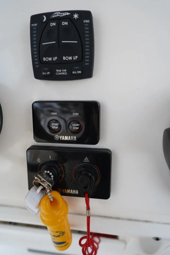 Slide: The Image of Control panel of a 2022 Cobia 266 boat with Yamaha switches. - 41
