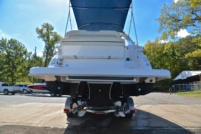 Slide: The Image of 2018 Regal 33 Express boat on trailer, rear view, outdoors with trees in background. - 16