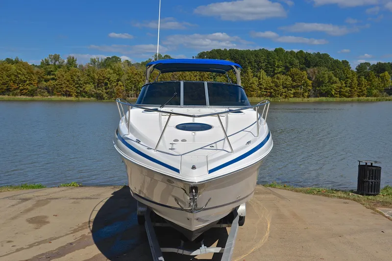 Slide: The Image of 2018 Regal 33 Express boat on trailer by a scenic lake. - 20