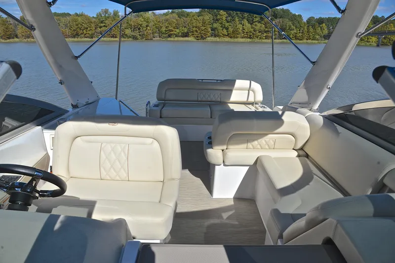 Slide: The Image of 2018 Regal 33 Express boat interior with luxurious seating on a serene lake. - 28