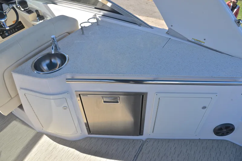 Slide: The Image of 2018 Regal 33 Express boat interior with sink and storage area. - 29