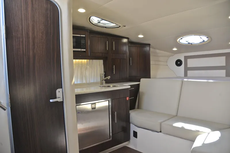 Slide: The Image of Luxurious interior of 2018 Regal 33 Express yacht with modern kitchen and seating area. - 33