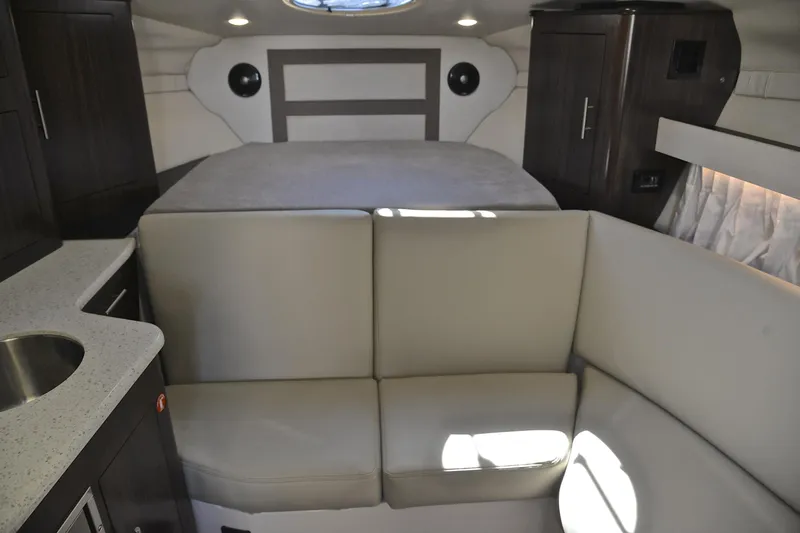 Slide: The Image of 2018 Regal 33 Express cabin interior with seating and kitchenette. - 34