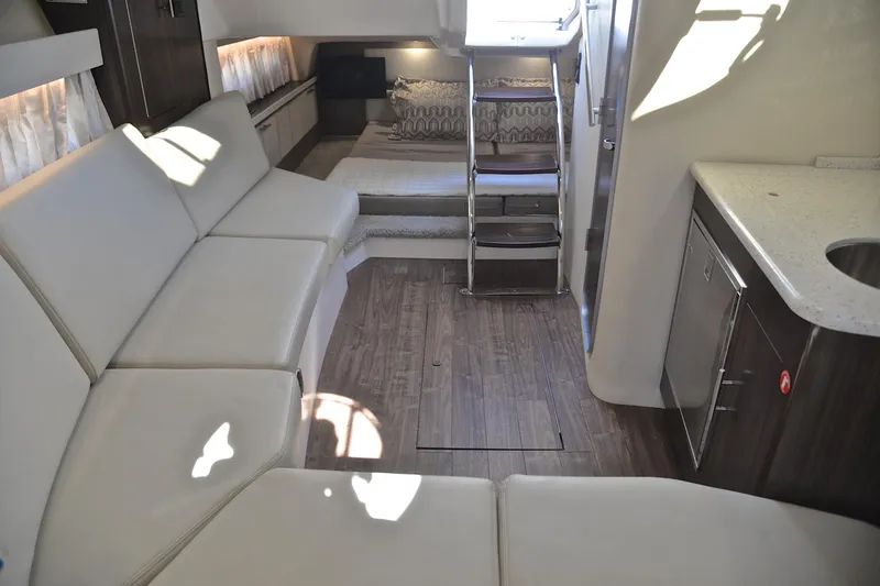Slide: The Image of Luxurious interior of 2018 Regal 33 Express yacht with modern seating and kitchenette. - 37