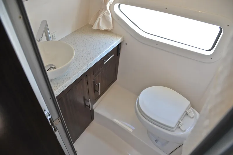 Slide: The Image of 2018 Regal 33 Express bathroom with modern sink, toilet, and window. - 39