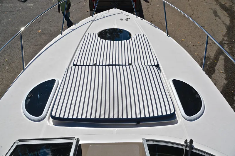Slide: The Image of 2018 Regal 33 Express boat deck with striped cushions and sleek design. - 40
