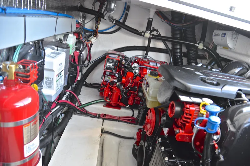 Slide: The Image of Engine compartment of 2018 Regal 33 Express boat, featuring red components and fire extinguisher. - 45
