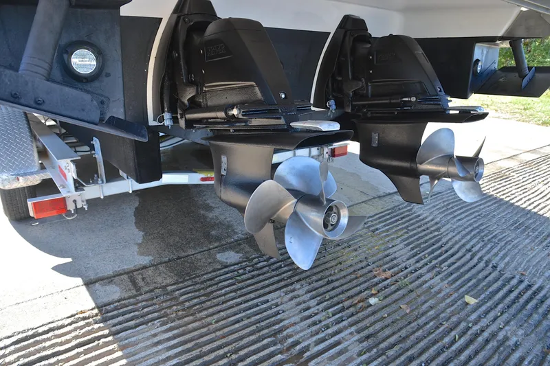 Slide: The Image of 2018 Regal 33 Express boat propellers on a trailer, showcasing dual outboard motors. - 47