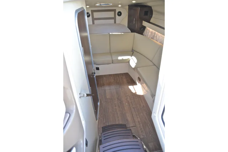 Slide: The Image of 2018 Regal 33 Express cabin interior with beige seating and wood flooring. - 48