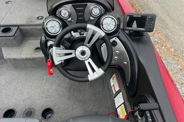 Slide: The Image of 2024 Tracker Pro Team 175 TXW boat dashboard with steering wheel and gauges. - 10