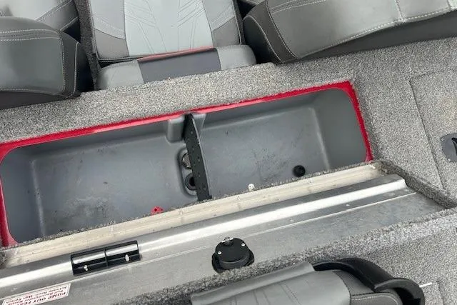 Slide: The Image of 2024 Tracker Pro Team 175 TXW boat interior storage compartment with gray seating. - 14