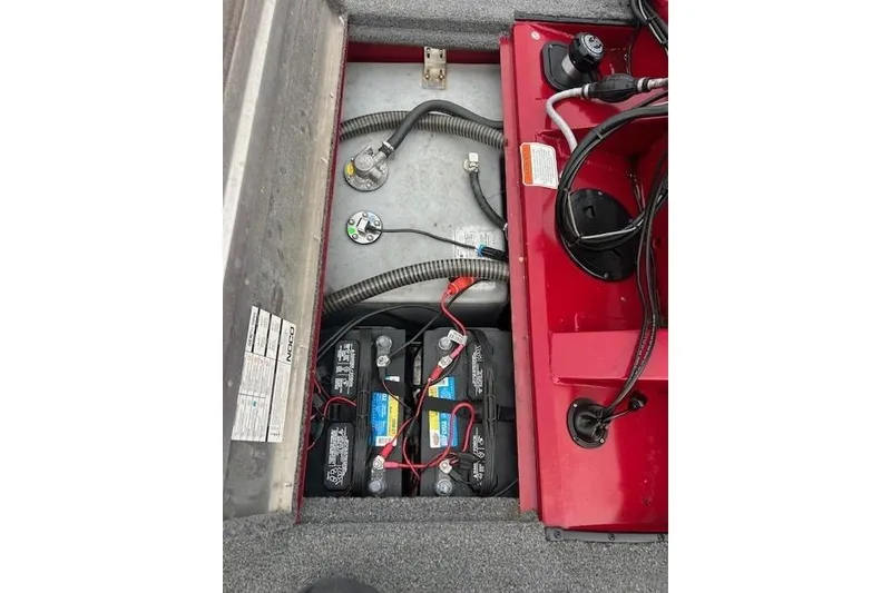 Slide: The Image of 2024 Tracker Pro Team 175 TXW boat battery compartment with wiring and components. - 15