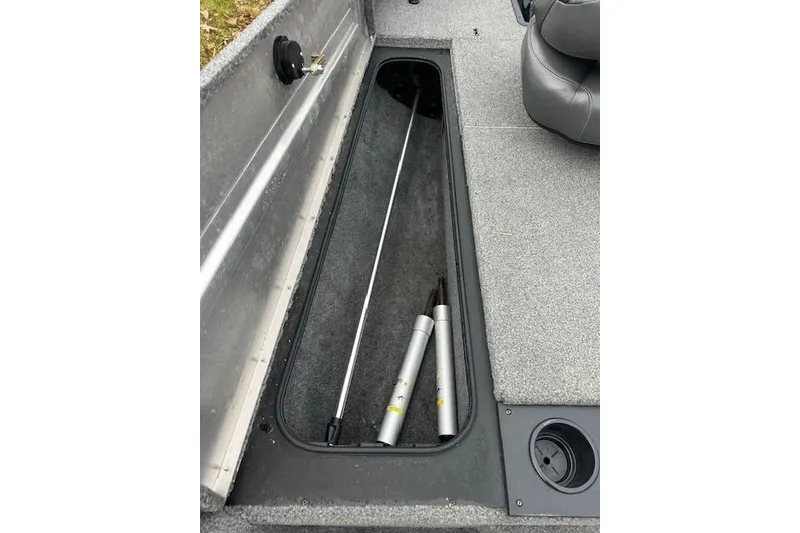 Slide: The Image of 2024 Tracker Pro Team 175 TXW boat storage compartment with fishing rod holders. - 20