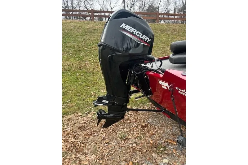 Slide: The Image of 2024 Tracker Pro Team 175 TXW boat with Mercury outboard motor, parked on grass. - 3