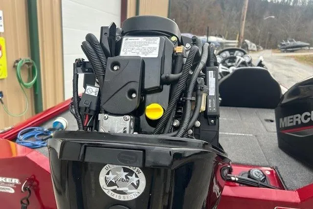 Slide: The Image of 2024 Tracker Pro Team 175 TXW boat engine close-up in a marina setting. - 5