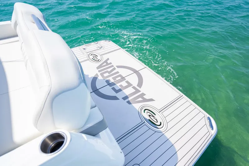 Slide: The Image of 2022 Regal 36 Grande Coupe boat deck on turquoise water. - 16