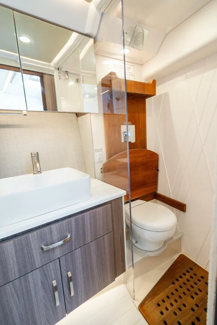 Slide: The Image of Luxurious bathroom in 2022 Regal 36 Grande Coupe yacht with modern fixtures and wood accents. - 23