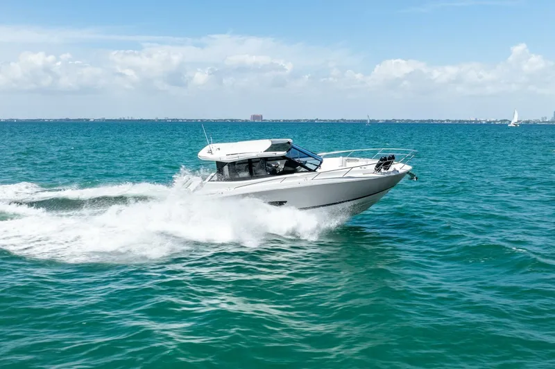 Slide: The Image of 2022 Regal 36 Grande Coupe cruising on open sea under clear skies. - 29