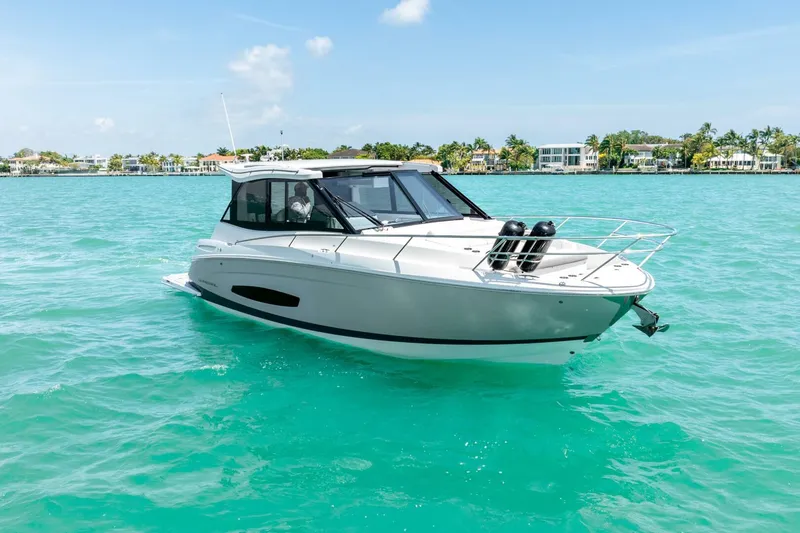 Slide: The Image of 2022 Regal 36 Grande Coupe yacht on turquoise water, clear sky background. - 33