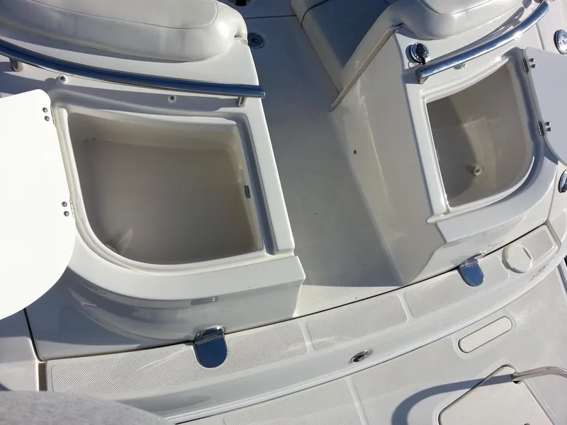 Slide: The Image of 2006 Monterey 233 Explorer boat storage compartments, open and empty, showcasing interior space. - 12