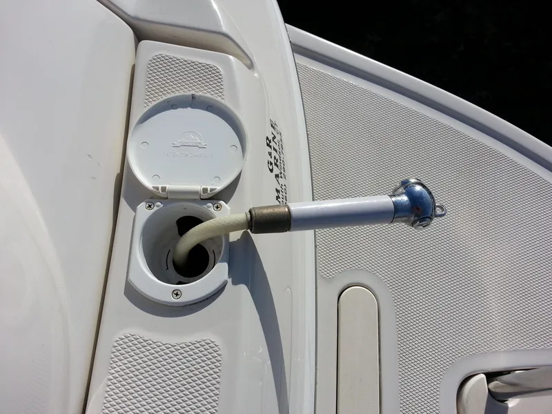 Slide: The Image of 2006 Monterey 233 Explorer boat deck with a shower hose and cover. - 14