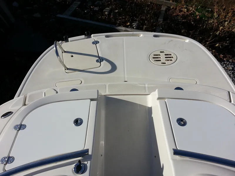 Slide: The Image of 2006 Monterey 233 Explorer boat deck with storage compartments and railing. - 15
