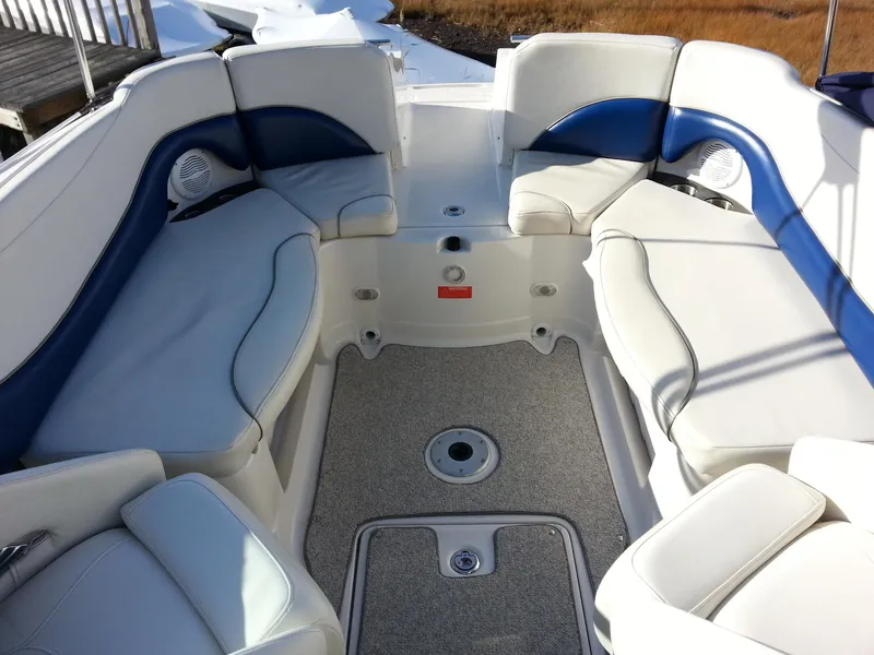 Slide: The Image of 2006 Monterey 233 Explorer boat interior with white and blue cushioned seating. - 16