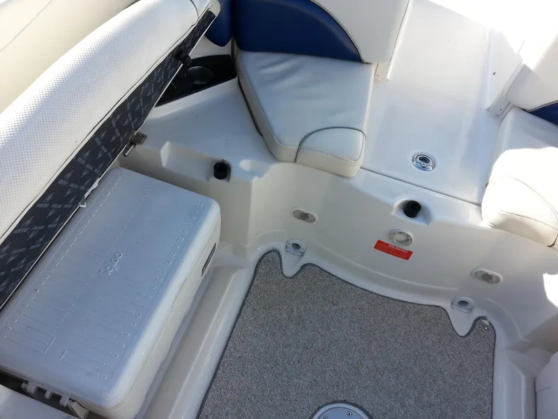 Slide: The Image of Interior of a 2006 Monterey 233 Explorer boat, featuring seating and storage. - 17