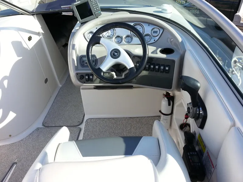 Slide: The Image of 2006 Monterey 233 Explorer boat cockpit with steering wheel and control panel. - 23