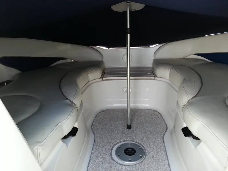 Slide: The Image of Interior of 2006 Monterey 233 Explorer boat with cushioned seating and table pole. - 26