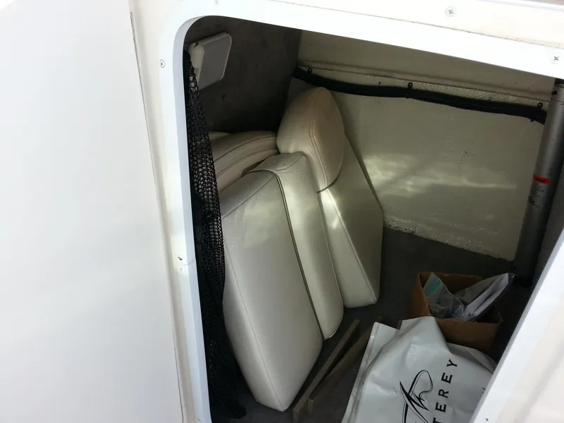 Slide: The Image of Storage compartment in a 2006 Monterey 233 Explorer boat with white cushions. - 27