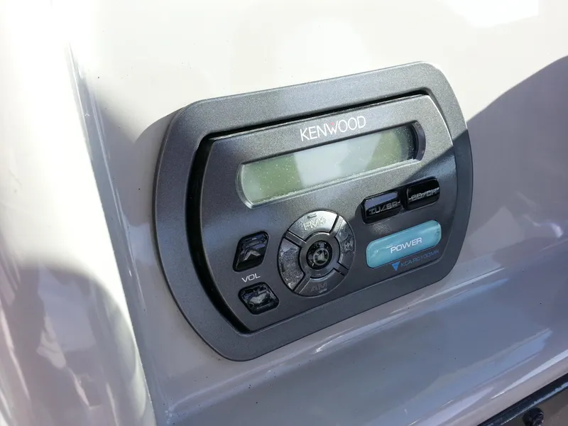 Slide: The Image of Kenwood audio control panel on 2006 Monterey 233 Explorer boat dashboard. - 28