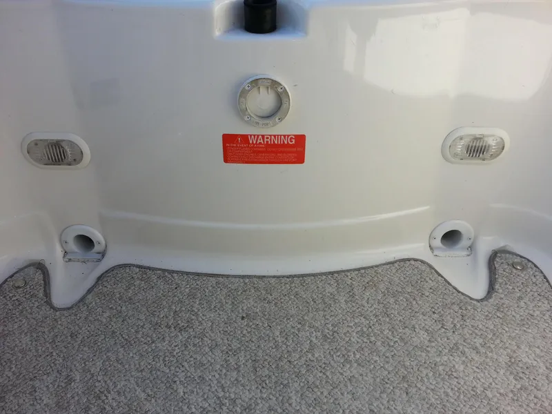 Slide: The Image of 2006 Monterey 233 Explorer boat interior with warning label and fittings. - 32