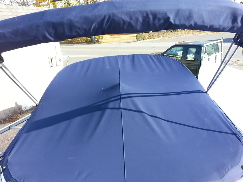 Slide: The Image of 2006 Monterey 233 Explorer boat with blue canvas cover and bimini top. - 35