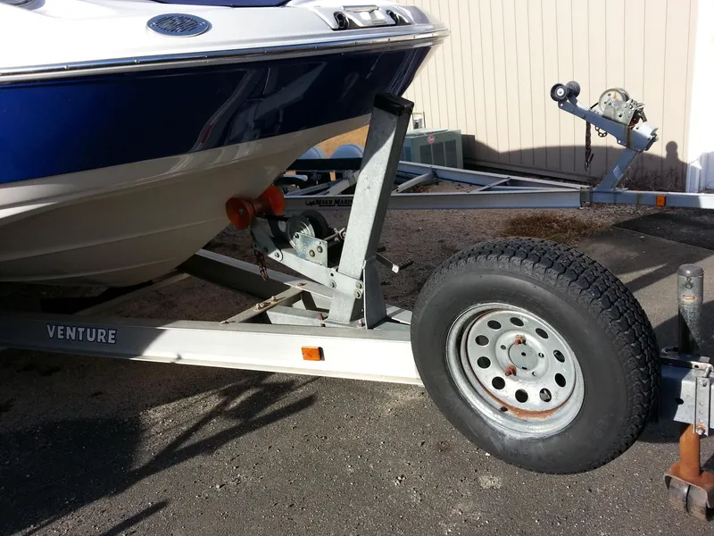Slide: The Image of 2006 Monterey 233 Explorer boat on Venture trailer, parked outdoors. - 37