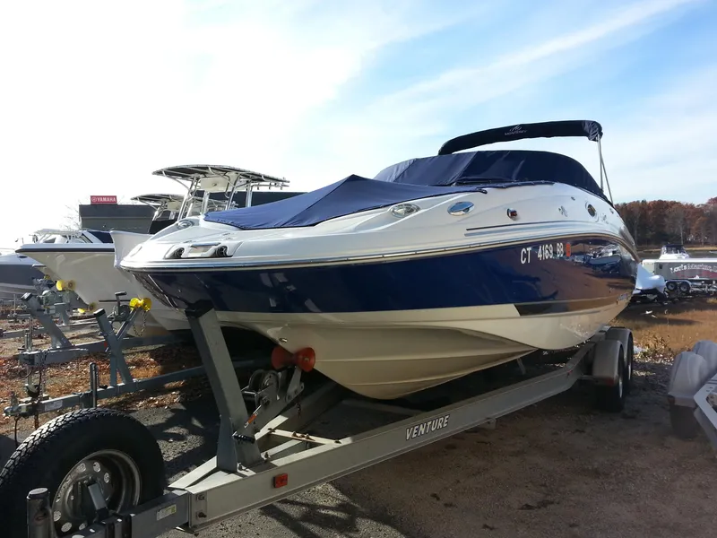 Slide: The Image of 2006 Monterey 233 Explorer boat on trailer, blue and white, parked outdoors. - 5