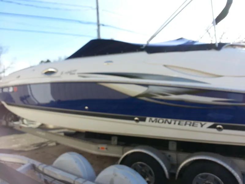 Slide: The Image of 2006 Monterey 233 Explorer boat on trailer, side view, blue and white design. - 7
