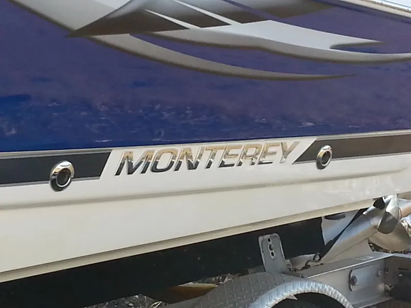 Slide: The Image of 2006 Monterey 233 Explorer boat, blue and white exterior, close-up view. - 9