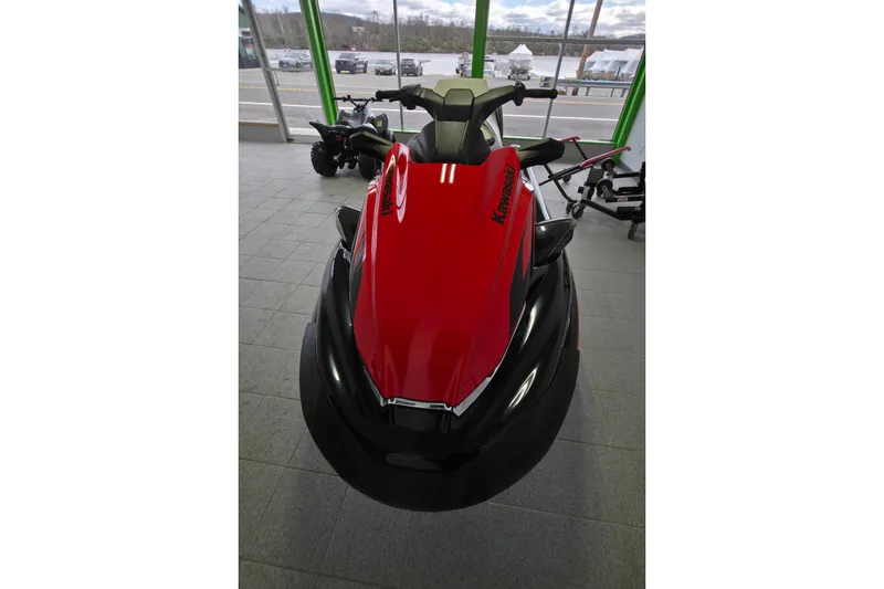 Slide: The Image of 2024 Kawasaki Jetski STX 160LX in showroom, front view, red and black design. - 3