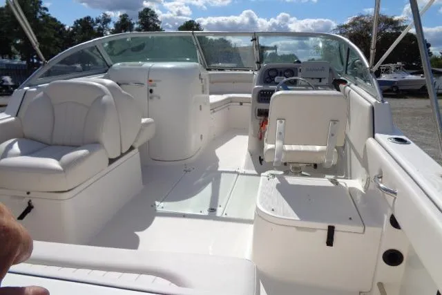 Slide: The Image of 2005 Robalo R227 Dual Console boat interior with white seating and control panel. - 10