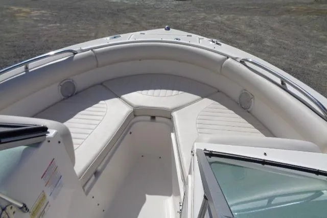 Slide: The Image of 2005 Robalo R227 Dual Console boat interior with white cushioned seating. - 11