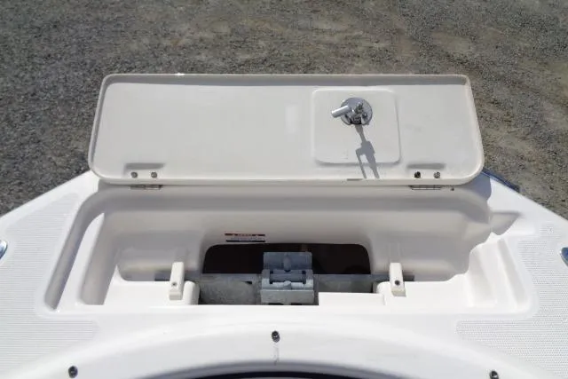 Slide: The Image of 2005 Robalo R227 Dual Console boat anchor storage compartment with open lid. - 13